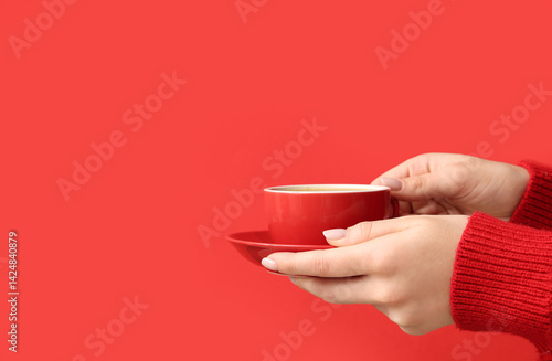 Female hands holding cup of...