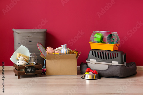 Unwanted stuff for garage sale near red wall