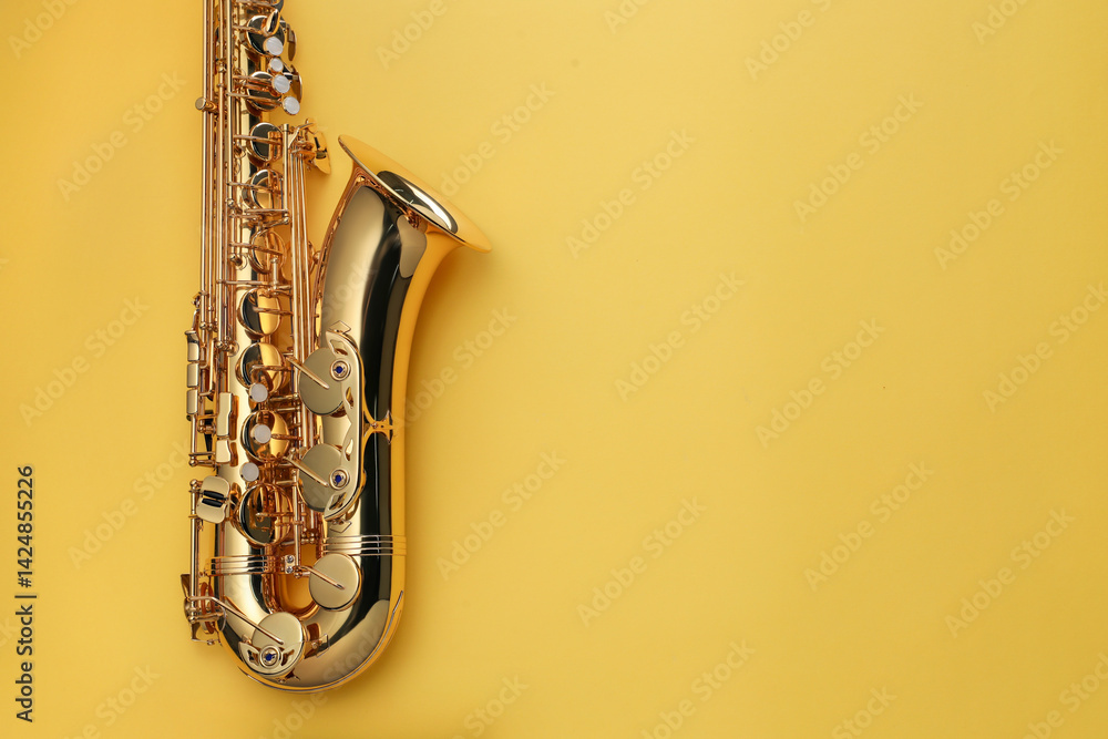Obraz premium Jazz. One saxophone on yellow background, top view. Space for text
