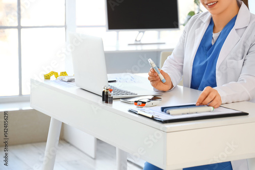 Female doctor with lancet p...