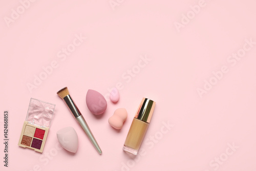 Obraz na płótnie Makeup sponges with brush, foundation and palette of eyeshadows on pink background w salonie