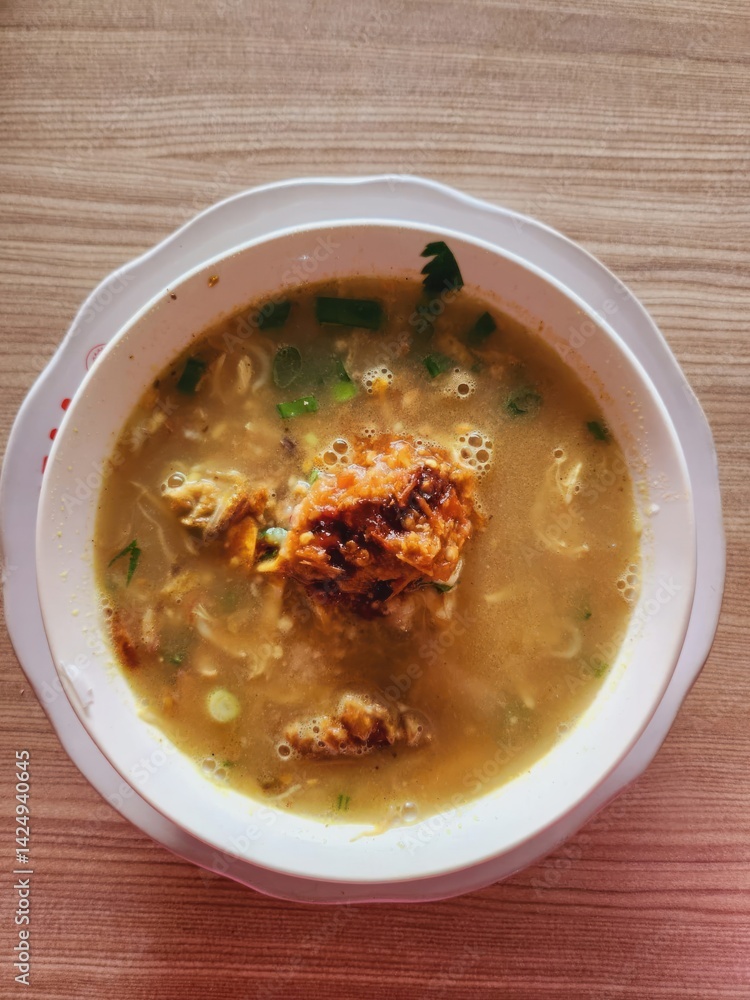 Bowl of flavorful noodle soup with crispy topping. Bowl of flavorful noodle soup with crispy topping.