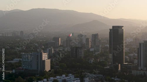 Wallpaper Mural Aerial perspective of a sunset in Mexico City, framed by buildings and with flag waving in distance Torontodigital.ca