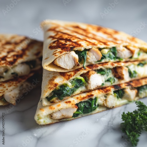 Delicious chicken and spinach quesadilla slices stacked on marble surface perfect for healthy recipes