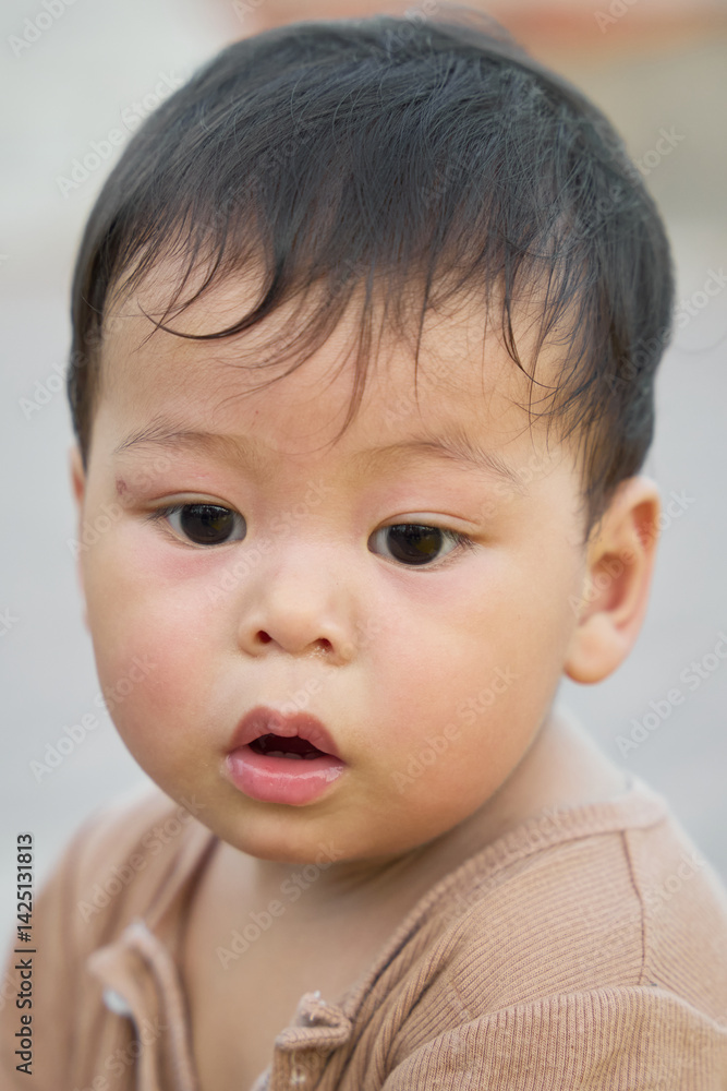 The baby is looking at the camera with a smile on his face, and he has a toothbrush in his mouth. The image captures a candid moment of the child's life, showcasing his innocence and playfulness. The baby is looking at the camera with a smile on his face, and he has a toothbrush in his mouth. The image captures a candid moment of the child's life, showcasing his innocence and playfulness.