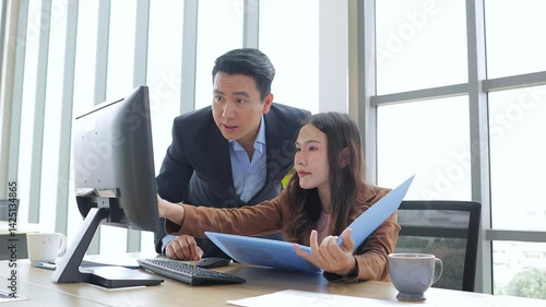 Asian businessman and businesswoman working in office discussing work. Business concept. Entrepreneur.