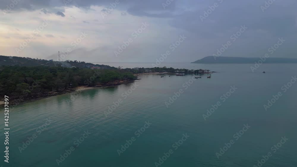Koh Rong Sanloem island village in Cambodia, featuring turquoise water, pier, boats and tropical jungle. Gorgeous aerial view flight rotation to right drone Koh Rong Sanloem island village in Cambodia, featuring turquoise water, pier, boats and tropical jungle. Gorgeous aerial view flight rotation to right drone