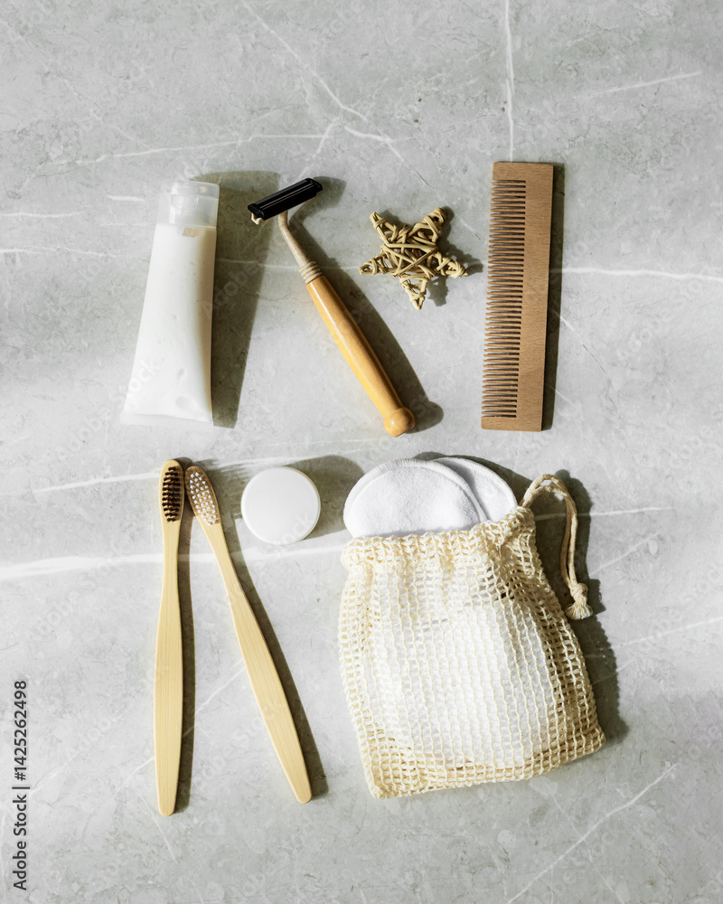 Minimal aesthetic lifestyle with Eco-Friendly Personal Care Products or natural Travel cosmetics essentials, bamboo toothbrushes, toothpaste, safety razor, facial reusable pads, shadow at sunlight