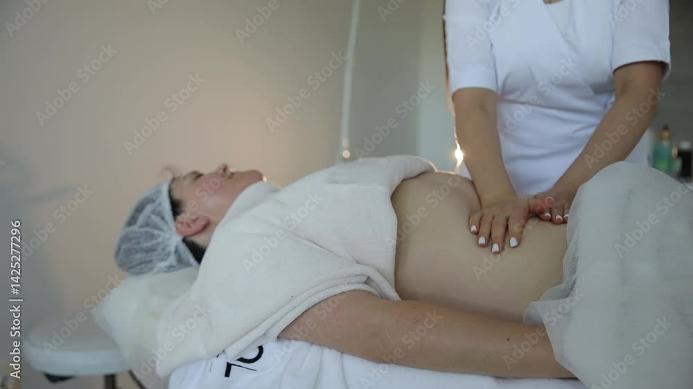 A relaxing abdominal massage in a tranquil spa that promotes healing and wellness A relaxing abdominal massage in a tranquil spa that promotes healing and wellness