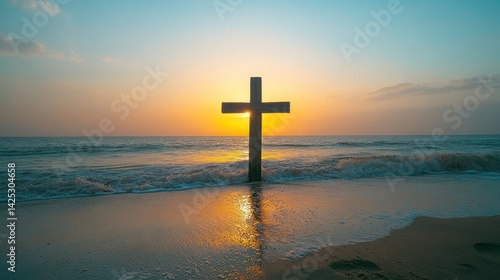 Wooden cross on beach at sunrise