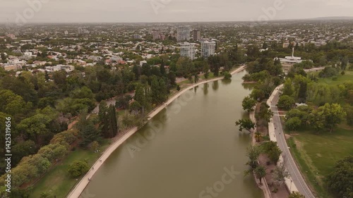 Wallpaper Mural 4K 60fps aerial footage over the lake in Parque General San Martin, Mendoza, Argentina. Features the city skyline in the background Torontodigital.ca