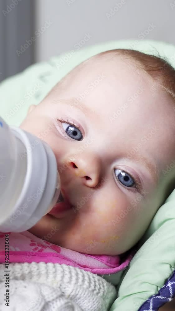 Baby drinking water from bottle while lying down, peaceful and calm atmosphere Baby drinking water from bottle while lying down, peaceful and calm atmosphere