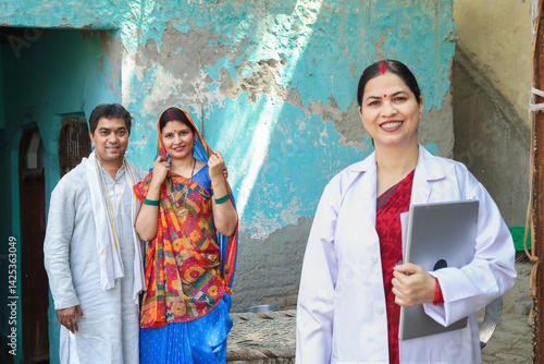 Portrait of Indian female doctor standing with couple patient at village prescribing medicine and medical test Rural india healthcare concept. Selective focus on husband wife. 