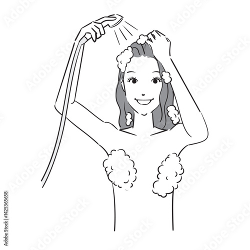 シャンプーした髪をシャワーで洗い流す女性
