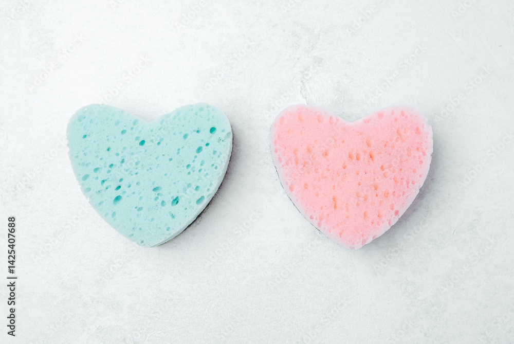 Fototapeta premium Colorful heart-shaped sponges in pastel tones for cleaning tasks