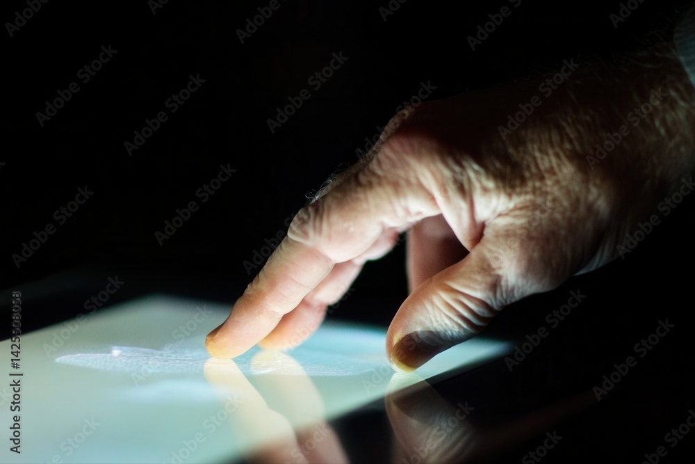 Close-up of a hand gently touching a glowing touchscreen, highlighting interaction with technology Close-up of a hand gently touching a glowing touchscreen, highlighting interaction with technology