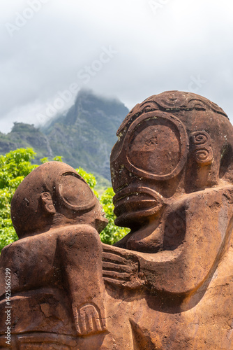 Ancient tiki statue with Mount Temetiu, Hiva Oa, French Polynesia