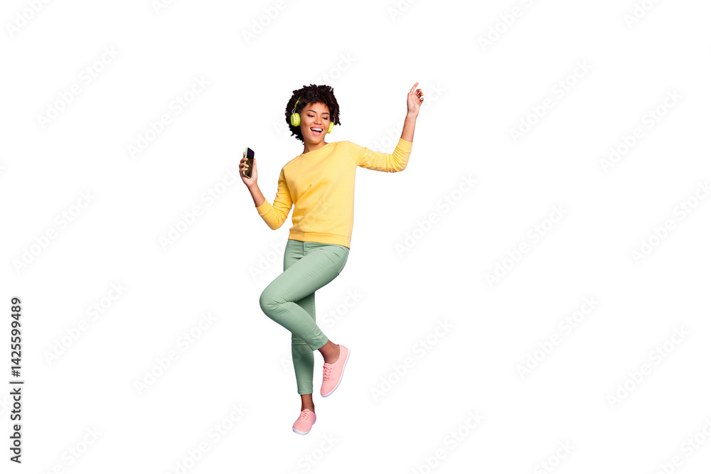 Full length body size photo of trendy stylish cute free girlfriend wearing green pants trousers yellow sweater footwear in headphones listening to music dancing isolated violet pastel color background Full length body size photo of trendy stylish cute free girlfriend wearing green pants trousers yellow sweater footwear in headphones listening to music dancing isolated violet pastel color background