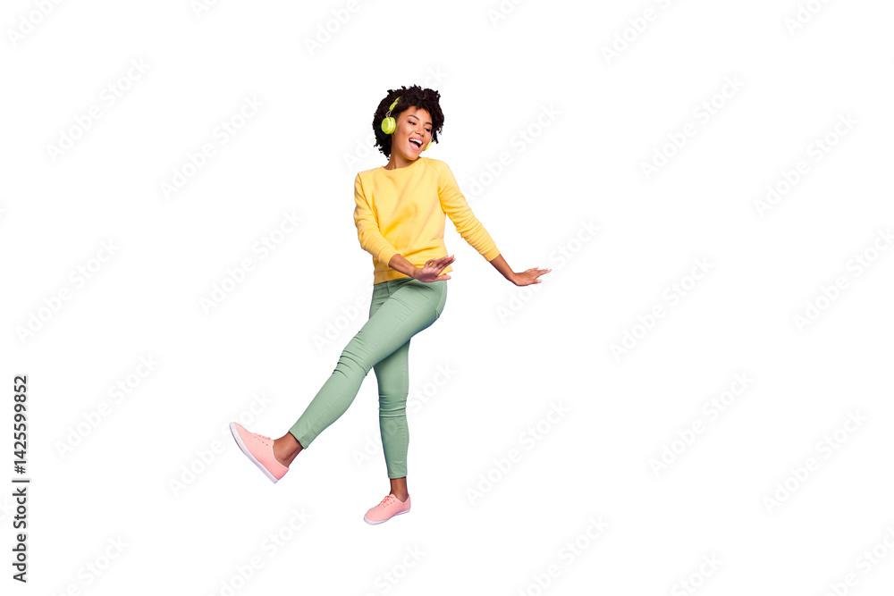 Full length body size photo of wavy curly haired sweet pretty girl of freedom wearing green pants trousers dancing listening to her music out of headphones isolated over violet color pastel background Full length body size photo of wavy curly haired sweet pretty girl of freedom wearing green pants trousers dancing listening to her music out of headphones isolated over violet color pastel background