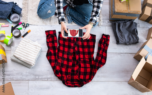 Girl Photographs Used Shirt On The Floor At Home For Online Selling
