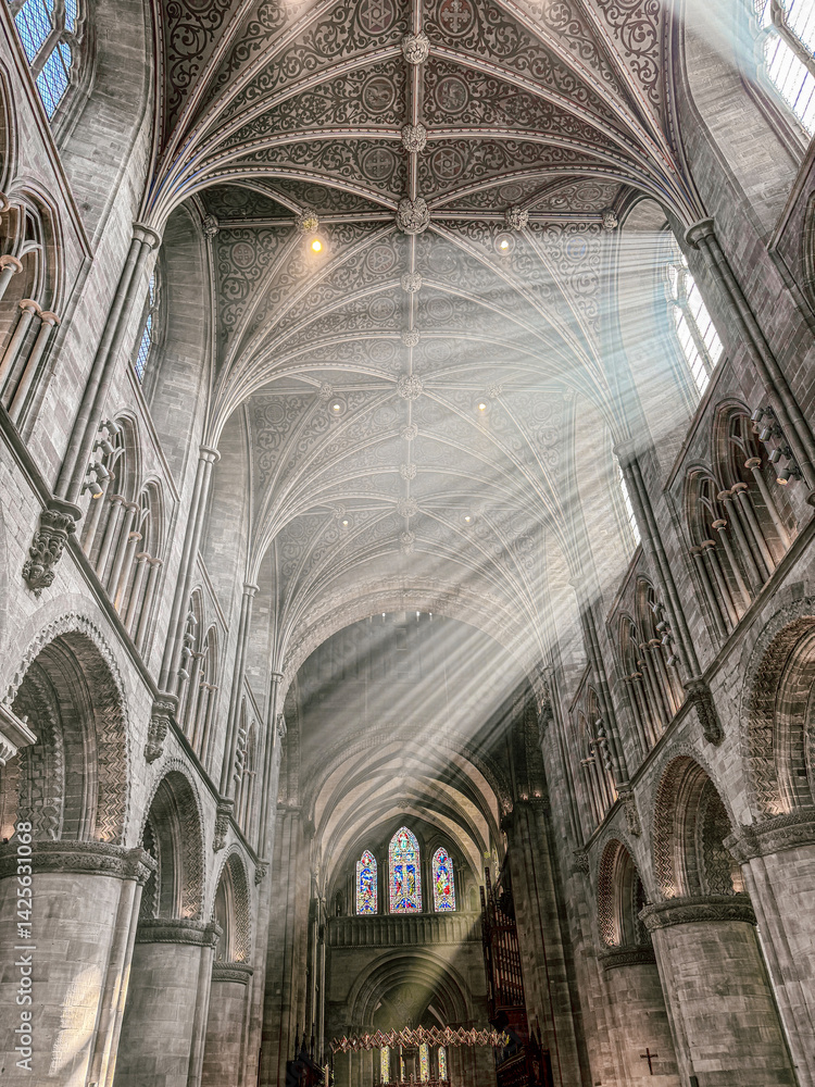 The vaulted ceiling of Hereford Cathedral, Herefordshire, England UK. The sun beams are visible in the incense smoke of the Easter Sunday morning service.