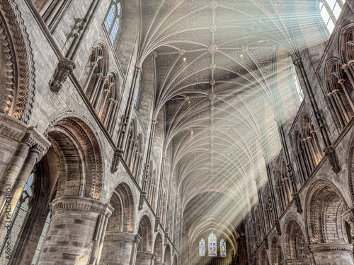 The vaulted ceiling of Hereford Cathedral, Herefordshire, England UK. The sun beams are visible in the incense smoke of the Easter Sunday morning service.