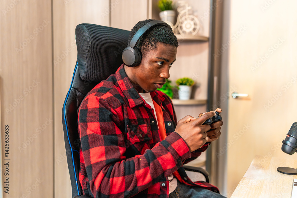 Focused gamer streaming live, playing video games with headset and controller