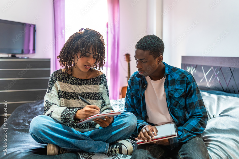 Students sharing notes and studying together on bed