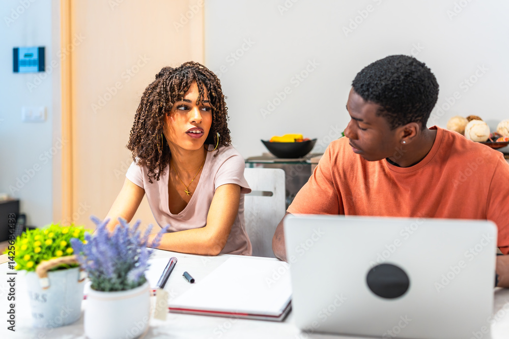 Young couple working from home having a discussion