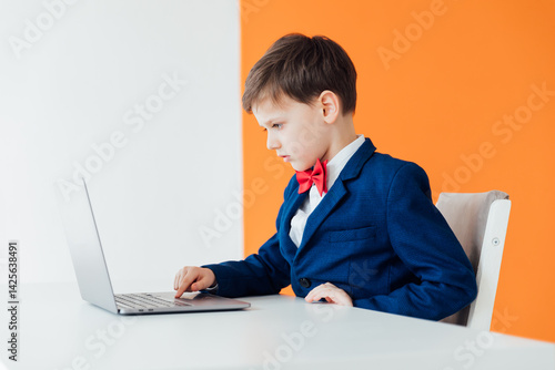 Boy in school uniform working on laptop