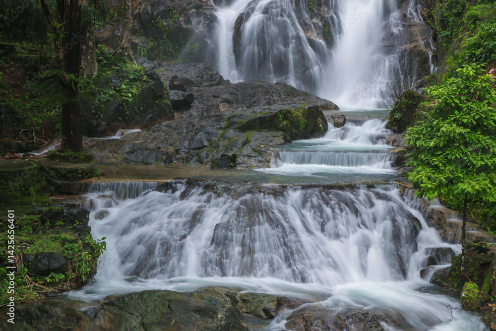 Obraz premium Punyaban Waterfall is a waterfall with water flowing all year round, located on Phetkasem Road, 2 kilometers from the National Park Office. It has 3 levels and is located in Mueang District, Ranong
