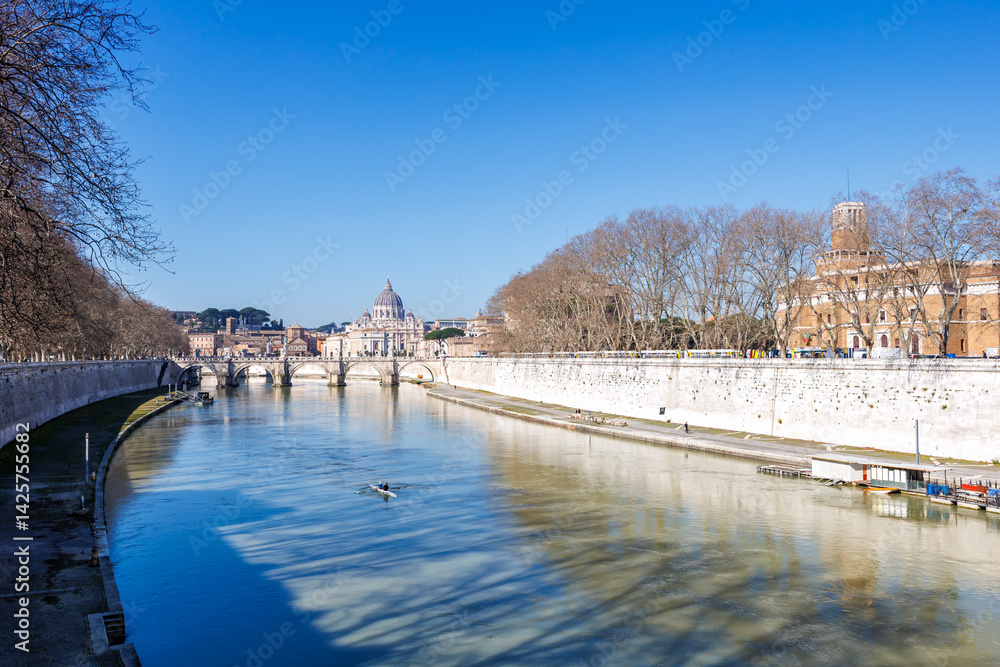 Rome skyline with St. Peter's Basilica in Vatican Ponte Sant'Angelo bridge over Tiber river in Italy