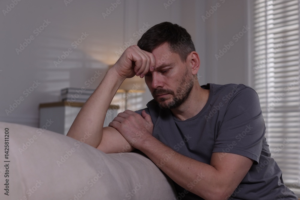 Depressed man on sofa at home. Mental health problem Depressed man on sofa at home. Mental health problem