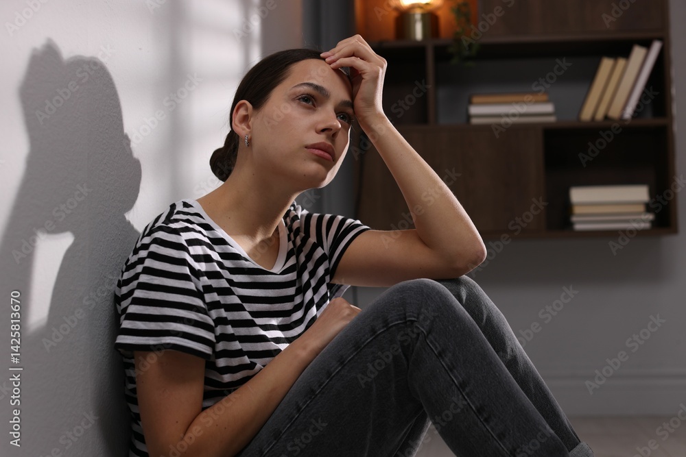 Obraz premium Depressed young woman on floor at home