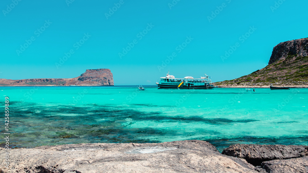 Serene coastal view with turquoise waters and distant rocky cliffs in Crete