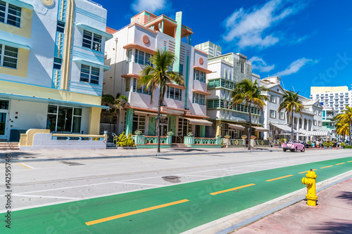A view along pastel coloured buildings on Ocean Drive on a bright sunny morning in South Beach in Miami in springtime