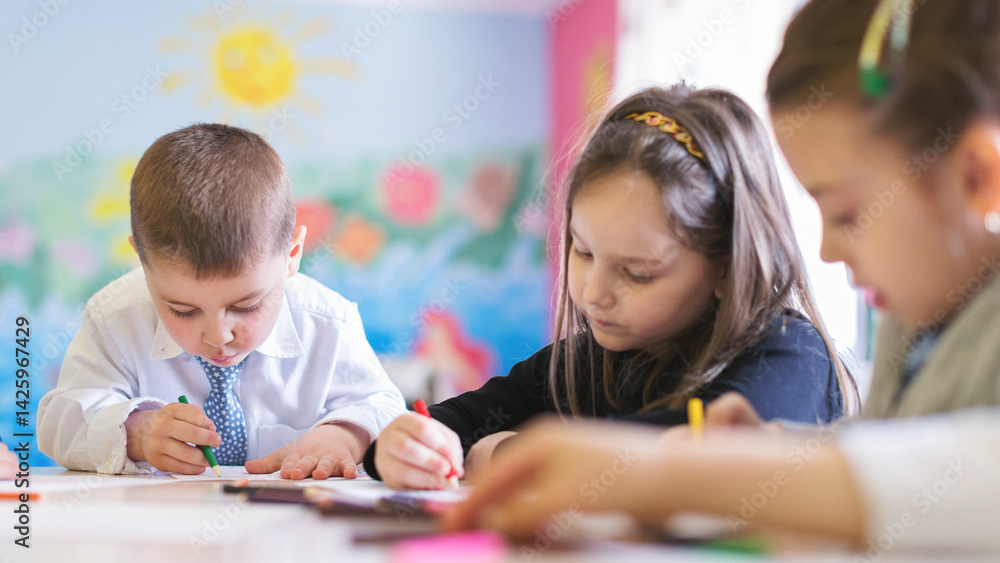 Fototapeta premium Group of children in classroom drawing