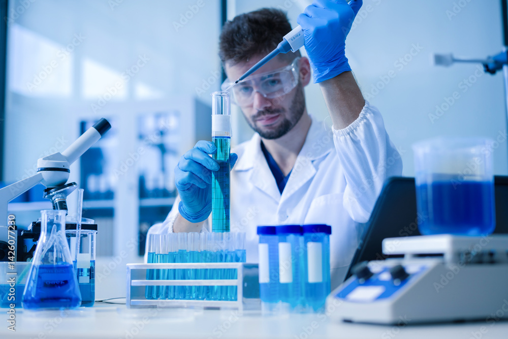 Fototapeta premium Chemist scientist holding test tube conducting experiment in laboratory with equipment.