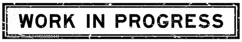 Grunge black work in progress word square rubber seal stamp on white bacckground