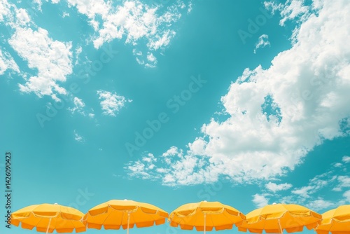 Bright yellow beach umbrellas under a clear blue sky on a sunny day