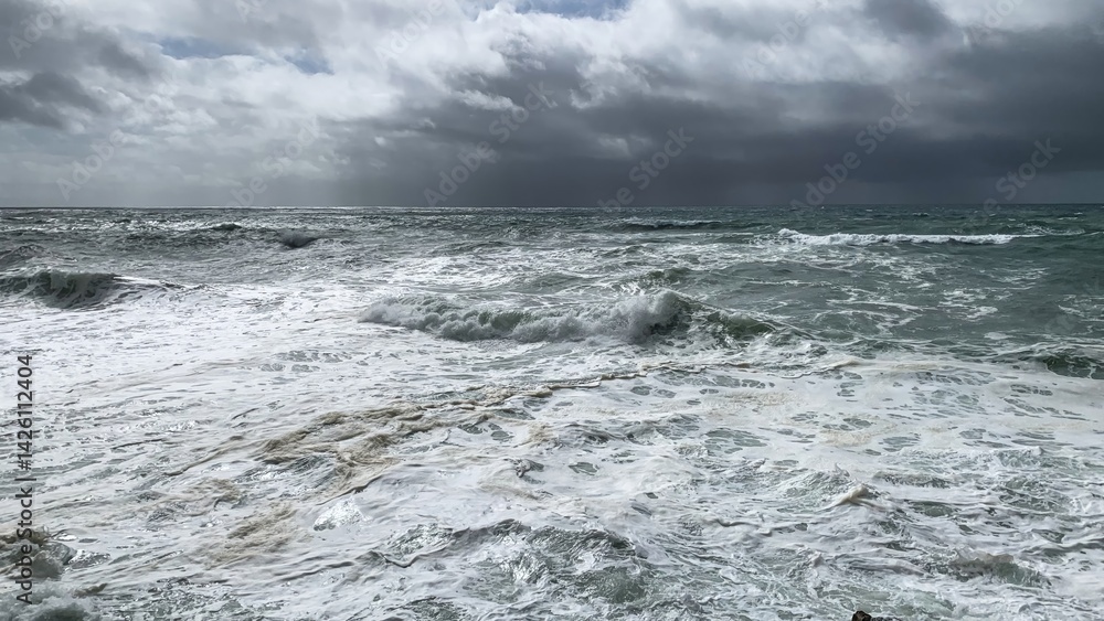Stormy ocean waves under a cloudy sky, symbolizing nature's power and adventure, World Oceans Day, nautical theme Stormy ocean waves under a cloudy sky, symbolizing nature's power and adventure, World Oceans Day, nautical theme