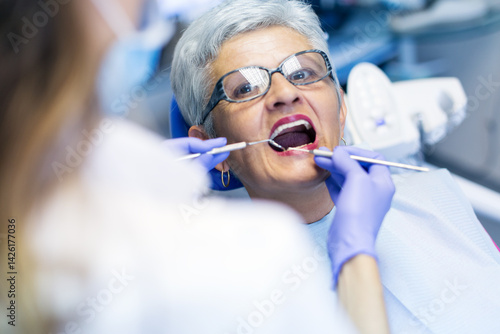 Portraits of patients in dental office having a dental check. Shallow DOF. Developed from RAW; retouched with special care and attention; Small amount of grain added for best final impression. 