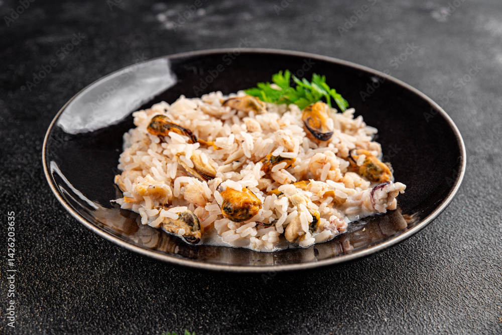 Seafood rice risotto frut de mer mussels, shrimp, prawn, rapan, squid vegetable dish fresh delicious gourmet food background on the table rustic food top view copy space Seafood rice risotto frut de mer mussels, shrimp, prawn, rapan, squid vegetable dish fresh delicious gourmet food background on the table rustic food top view copy space
