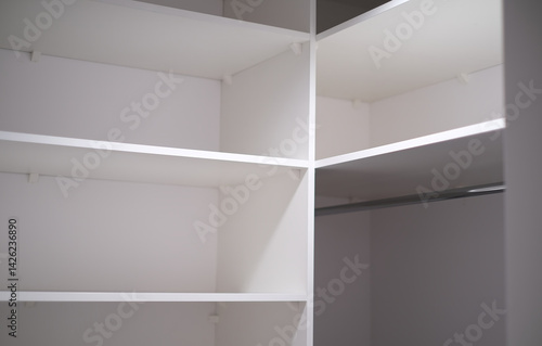 Wallpaper Mural Minimalist white closet interior with clean, empty shelves and a clothing rod. Torontodigital.ca