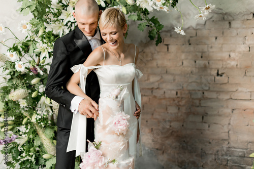 Young couple in love cutting their beautiful wedding cake