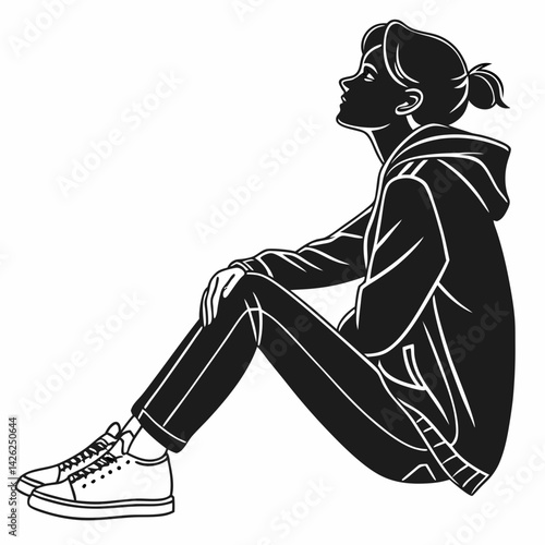 Woman sitting on ground in relaxed thoughtful pose