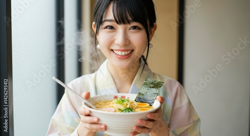 Woman eating ramen, smiling