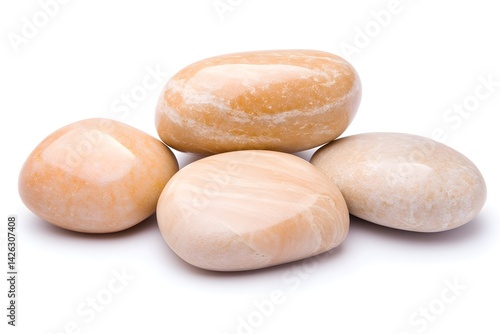 Four smooth, pale orange stones, polished and arranged on white background