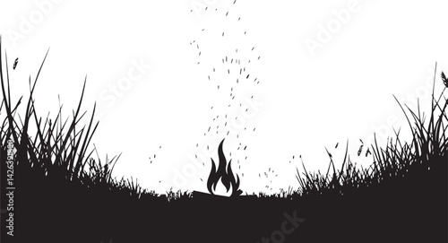 Black silhouette of a small campfire burning in the middle of tall grass with sparks and smoke rising