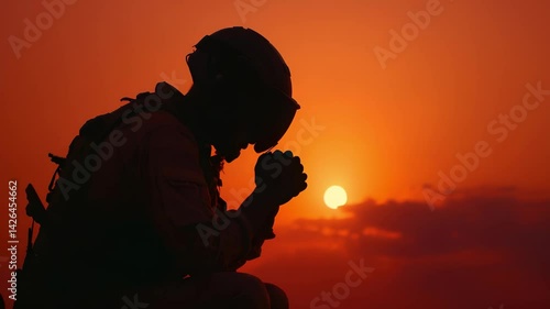 Soldier kneels in solemn prayer at sunset, his silhouette etched against fading light. Between grief for fallen and hope for survival, powerful moment, soldiers silent battle with faith, fear and duty
